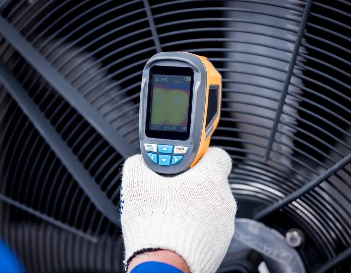 Technician performing diagnostic check on HVAC system